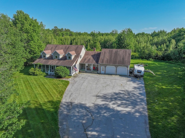 78 Lakeview Rd, Glenburn, ME 04401 - cape cod home with covered porch, driveway, a garage, and a wooded view