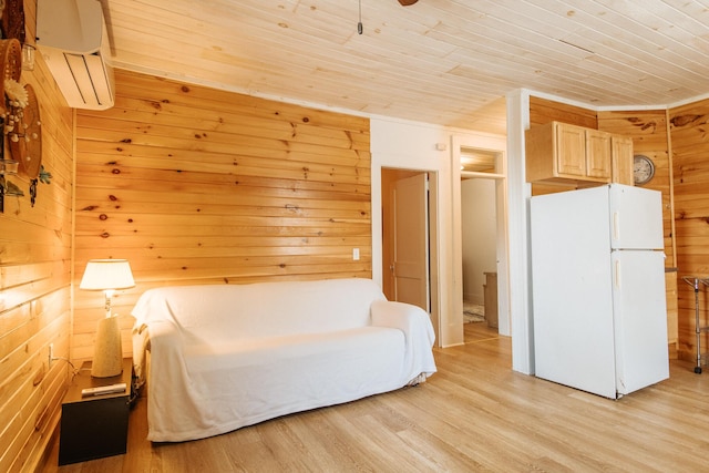 18/20 Beech St, East Millinocket, ME 04430 - bedroom with freestanding refrigerator, a wall unit AC, wood ceiling, wooden walls, and light wood finished floors