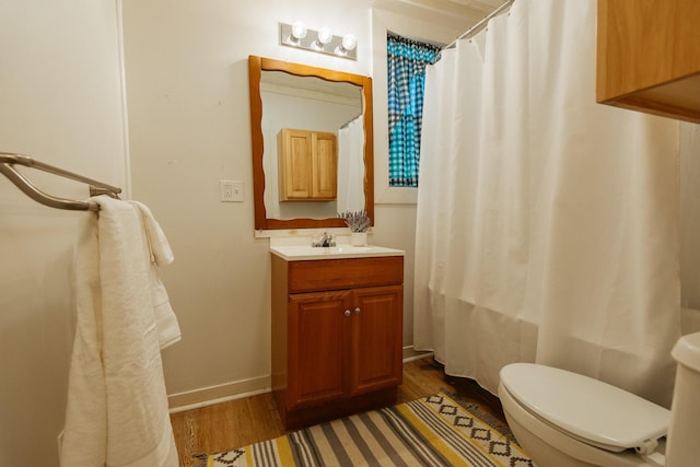18/20 Beech St, East Millinocket, ME 04430 - full bathroom with wood finished floors, vanity, and a shower with shower curtain