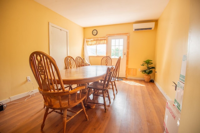 18/20 Beech St, East Millinocket, ME 04430 - dining room with an AC wall unit and light wood-type flooring