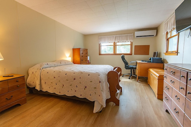 18/20 Beech St, East Millinocket, ME 04430 - bedroom with light wood-style flooring and a wall mounted air conditioner