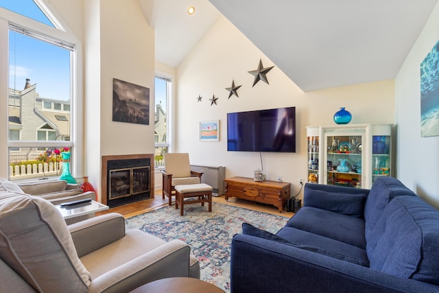 36 Ocean House Way Unit E4, York, ME 03909 - living room with wood finished floors, a fireplace, and high vaulted ceiling