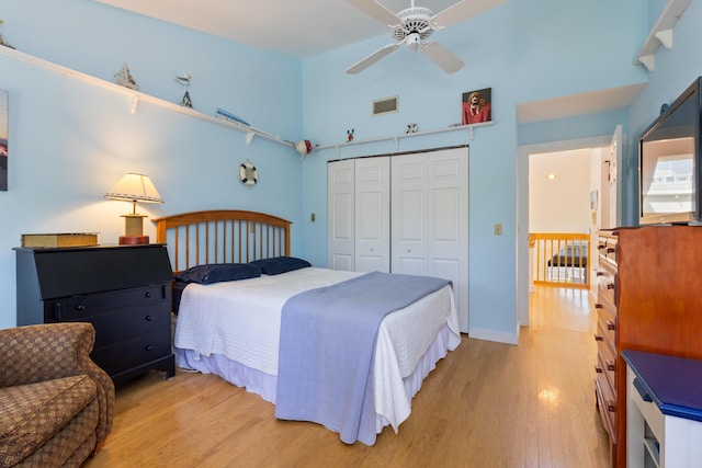 36 Ocean House Way Unit E4, York, ME 03909 - bedroom featuring light wood finished floors, a closet, a high ceiling, and a ceiling fan