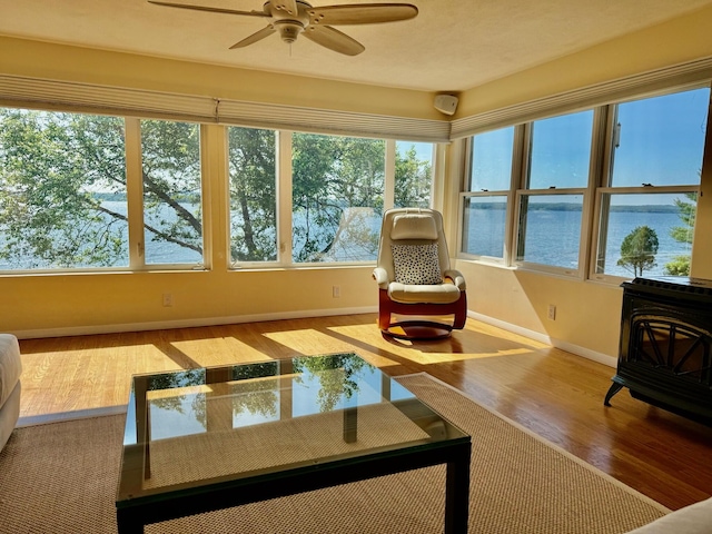 48 Sheltons Rd, Trenton, ME 04605 - sunroom / solarium featuring a wood stove, wood finished floors, and healthy amount of natural light