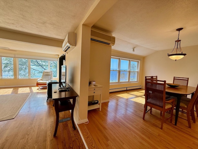 48 Sheltons Rd, Trenton, ME 04605 - dining area featuring a wall mounted air conditioner, a baseboard heating unit, a textured ceiling, wood finished floors, and vaulted ceiling