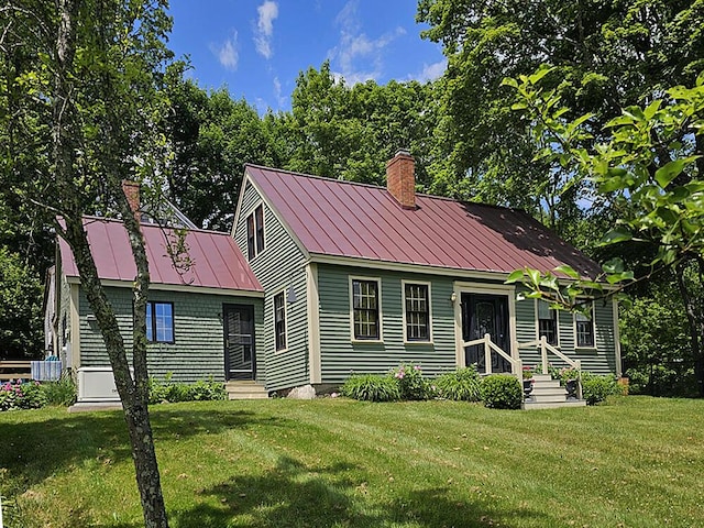 8 Longfellow School Rd, Bristol, ME 04539 - view of front of house with a chimney, a front yard, a metal roof, and a standing seam roof