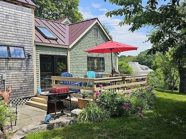 8 Longfellow School Rd, Bristol, ME 04539 - rear view of house with a standing seam roof, a wooden deck, a metal roof, and a yard