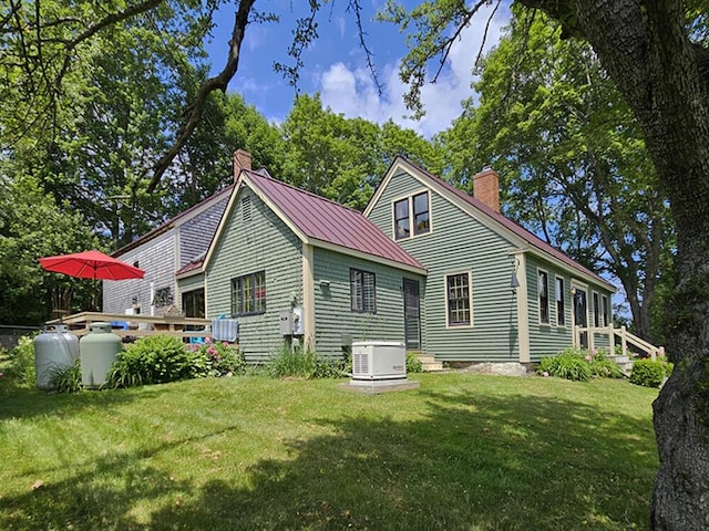 8 Longfellow School Rd, Bristol, ME 04539 - rear view of property with a chimney, a lawn, and a metal roof