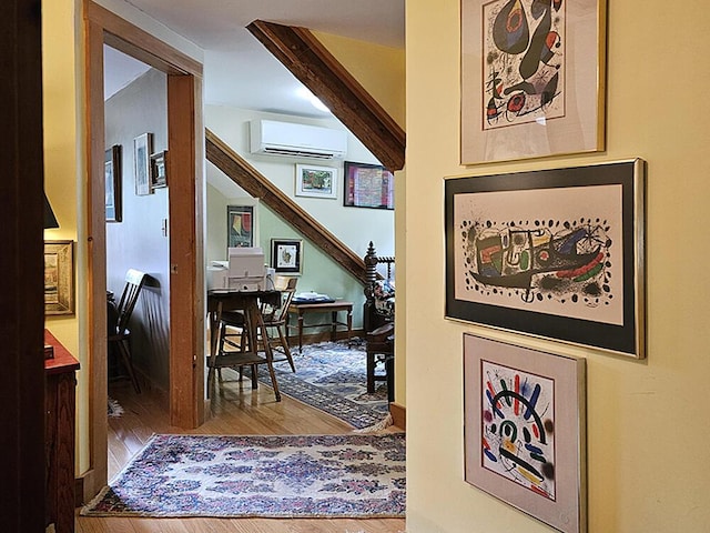 8 Longfellow School Rd, Bristol, ME 04539 - hallway with a wall mounted air conditioner, wood finished floors, and a desk