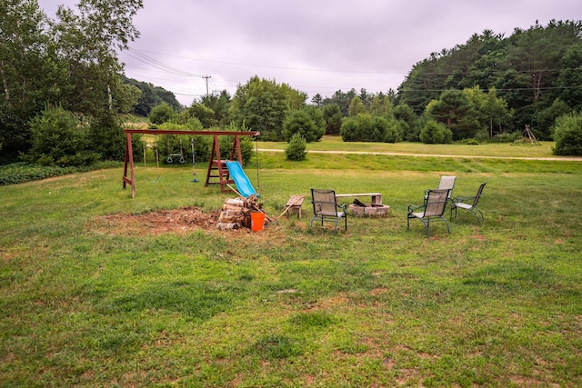 7 Dakin Rd, Turner, ME 04282 - view of grassy yard with a playground and a fire pit