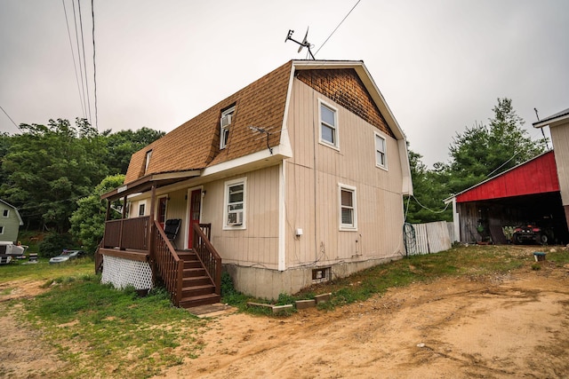 7 Dakin Rd, Turner, ME 04282 - view of property exterior featuring a shingled roof, a gambrel roof, and a porch