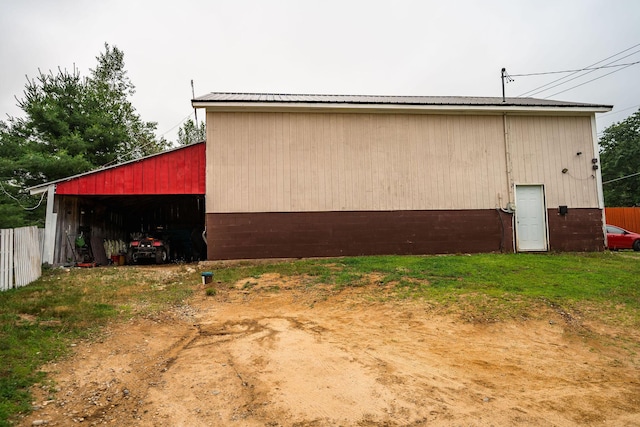 7 Dakin Rd, Turner, ME 04282 - view of property exterior featuring a pole building, a metal roof, an outdoor structure, and a detached garage