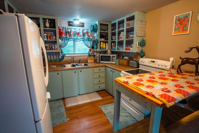 7 Dakin Rd, Turner, ME 04282 - kitchen featuring white appliances, green cabinets, open shelves, light wood-style flooring, and a peninsula