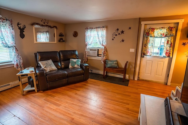 7 Dakin Rd, Turner, ME 04282 - living room with cooling unit, light wood-style flooring, and a baseboard heating unit