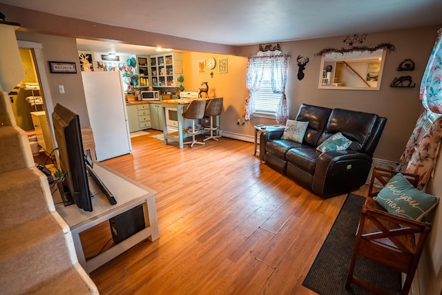 7 Dakin Rd, Turner, ME 04282 - living area featuring light wood-style floors, baseboard heating, and an office area