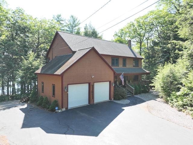 42 Knowles Point Rd, Bridgton, ME 04009 - chalet / cabin featuring asphalt driveway, a porch, a shingled roof, stairs, and a garage