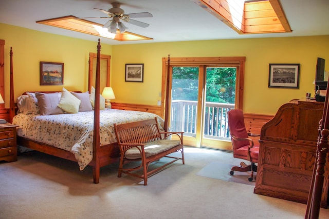 42 Knowles Point Rd, Bridgton, ME 04009 - bedroom with access to outside, carpet, a wainscoted wall, a skylight, and a ceiling fan