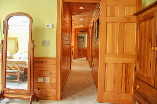 42 Knowles Point Rd, Bridgton, ME 04009 - hallway featuring light carpet, wooden walls, arched walkways, and recessed lighting