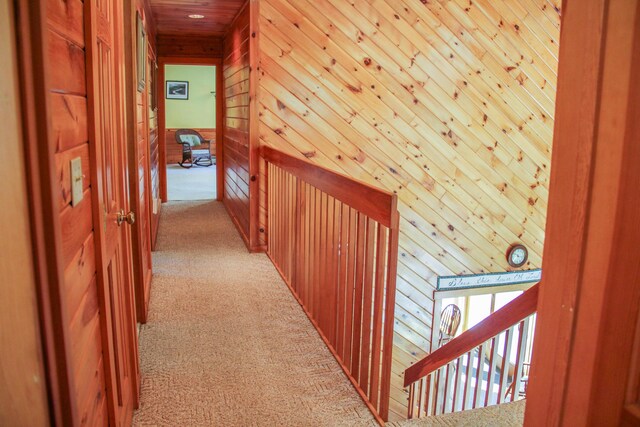 42 Knowles Point Rd, Bridgton, ME 04009 - corridor with light colored carpet, wooden walls, wooden ceiling, and an upstairs landing