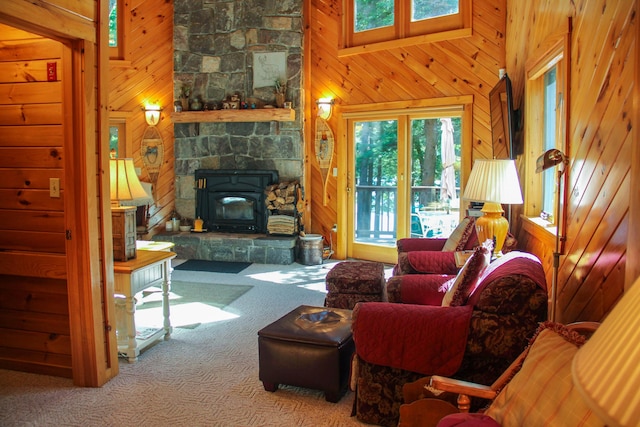 42 Knowles Point Rd, Bridgton, ME 04009 - carpeted living area with wooden walls, a wood stove, and a towering ceiling