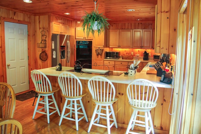 42 Knowles Point Rd, Bridgton, ME 04009 - kitchen featuring appliances with stainless steel finishes, light countertops, a peninsula, recessed lighting, and light wood-type flooring