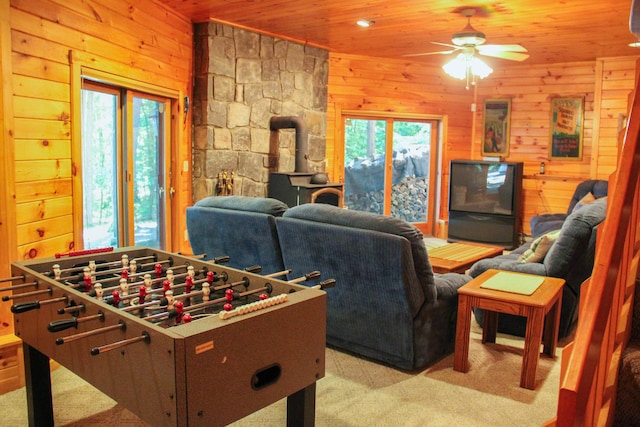 42 Knowles Point Rd, Bridgton, ME 04009 - game room featuring a wood stove, plenty of natural light, wooden ceiling, a ceiling fan, and light carpet