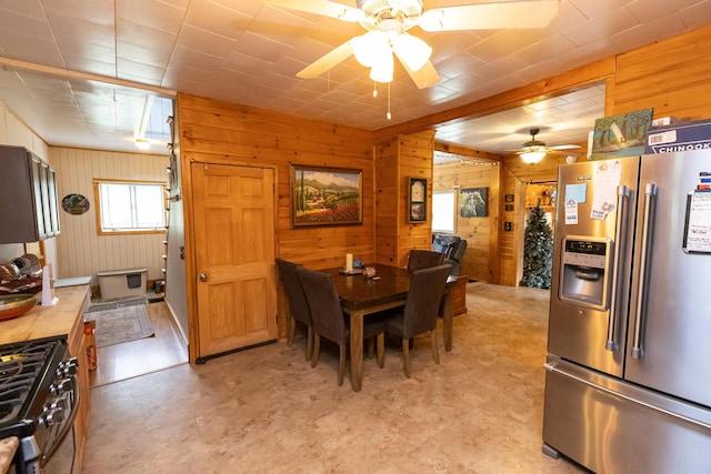 143 Mayfield Rd, Moscow, ME 04920 - dining area with a ceiling fan, light floors, and wooden walls