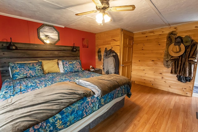 143 Mayfield Rd, Moscow, ME 04920 - bedroom featuring wood finished floors, wood walls, and a ceiling fan