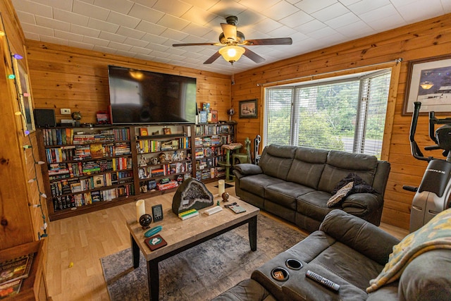 143 Mayfield Rd, Moscow, ME 04920 - living room featuring wood walls, wood finished floors, and ceiling fan