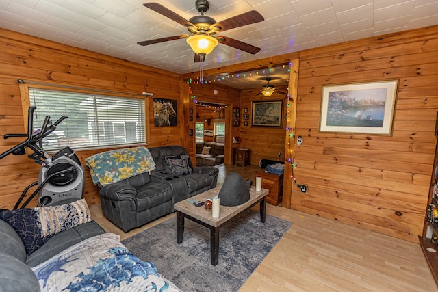 143 Mayfield Rd, Moscow, ME 04920 - living room featuring wood walls, ceiling fan, and wood finished floors