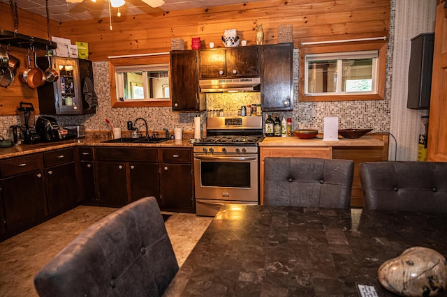 143 Mayfield Rd, Moscow, ME 04920 - kitchen featuring stainless steel range with gas cooktop, under cabinet range hood, ceiling fan, dark brown cabinetry, and backsplash