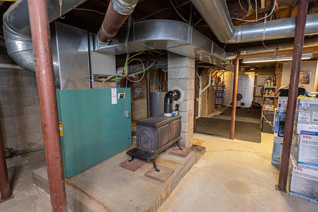 143 Mayfield Rd, Moscow, ME 04920 - unfinished basement featuring a wood stove and water heater