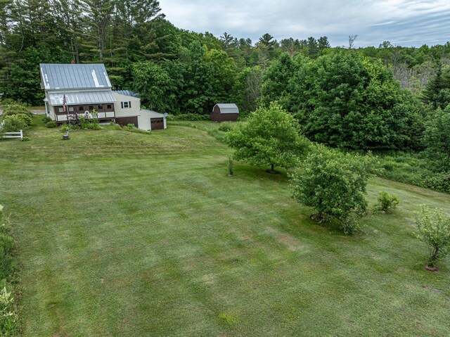143 Mayfield Rd, Moscow, ME 04920 - view of grassy yard featuring a wooded view and an outdoor structure