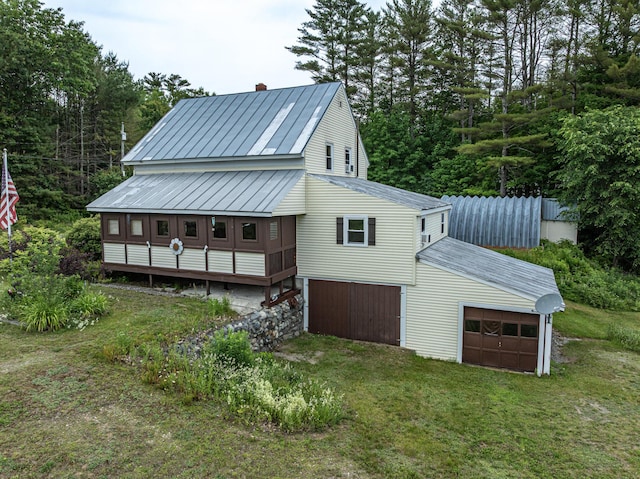 143 Mayfield Rd, Moscow, ME 04920 - back of house featuring a garage, a metal roof, a chimney, and a standing seam roof