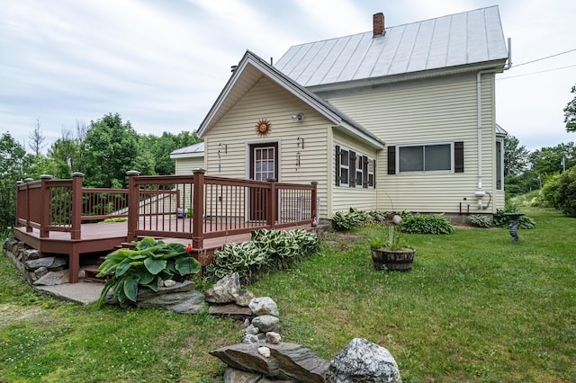 143 Mayfield Rd, Moscow, ME 04920 - back of property with a standing seam roof, a yard, a deck, and a metal roof