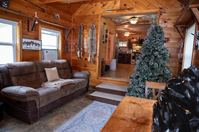 143 Mayfield Rd, Moscow, ME 04920 - living area with wooden walls, cooling unit, a ceiling fan, vaulted ceiling, and stone finish floors