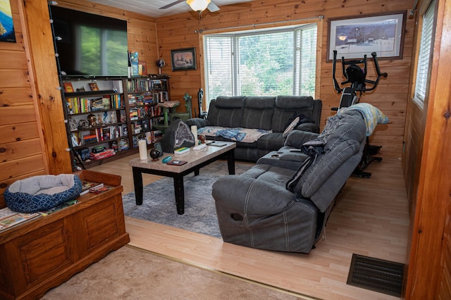 143 Mayfield Rd, Moscow, ME 04920 - living area featuring wood finished floors, wooden walls, and ceiling fan