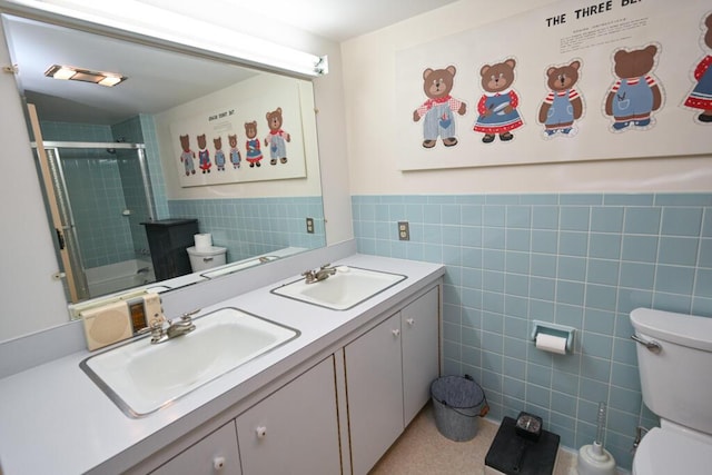 337 Copeland Hill Rd, Holden, ME 04429 - bathroom with tile walls, double vanity, and a wainscoted wall