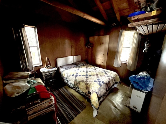 PE021 01 Unit T1 R8, Wels, ME 04462 - bedroom featuring multiple windows, wooden walls, and beam ceiling