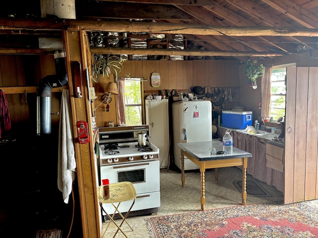 PE021 01 Unit T1 R8, Wels, ME 04462 - kitchen with white gas range, wooden walls, tile patterned floors, and refrigerator