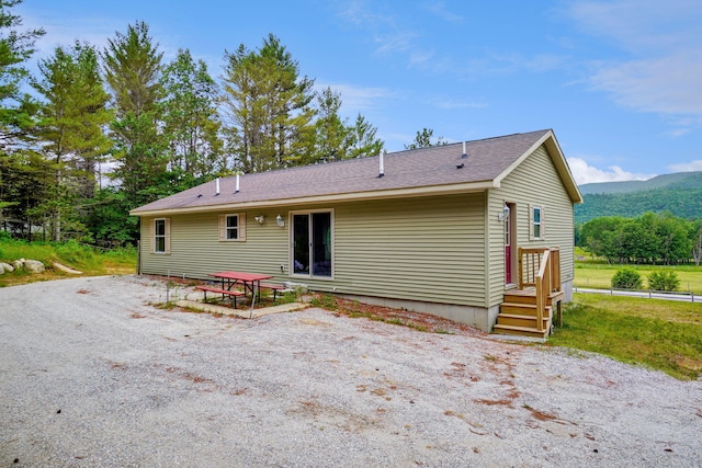 452 Flat Rd, Bethel, ME 04217 - rear view of property with a mountain view