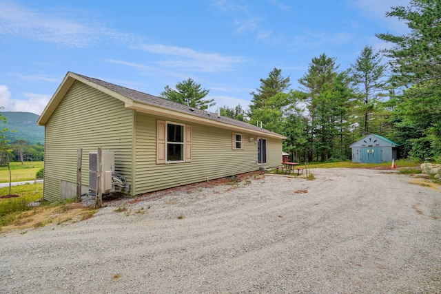 452 Flat Rd, Bethel, ME 04217 - view of home's exterior with driveway and an outdoor structure