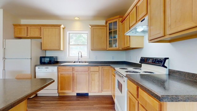 452 Flat Rd, Bethel, ME 04217 - kitchen with white appliances, under cabinet range hood, dark countertops, glass insert cabinets, and dark wood-style flooring