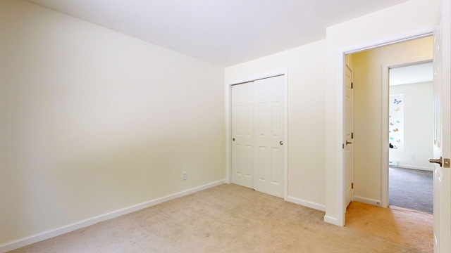452 Flat Rd, Bethel, ME 04217 - unfurnished bedroom featuring light carpet and a closet