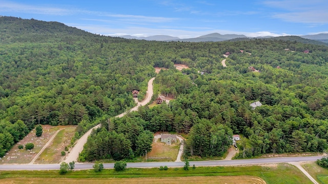 452 Flat Rd, Bethel, ME 04217 - drone / aerial view of a heavily wooded area and a mountain backdrop