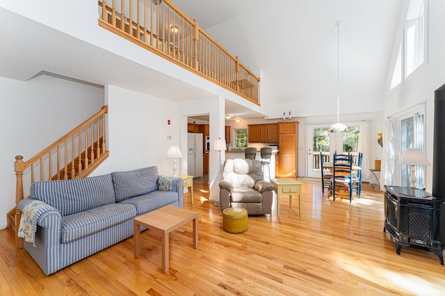 61 Dwelly Point Rd, Franklin, ME 04634 - living area featuring a high ceiling, light wood finished floors, a wood stove, and stairs