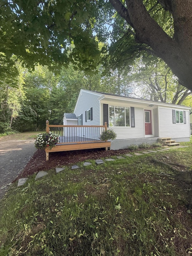 69 Heath St, Oakland, ME 04963 - view of front of house with a wooden deck and entry steps