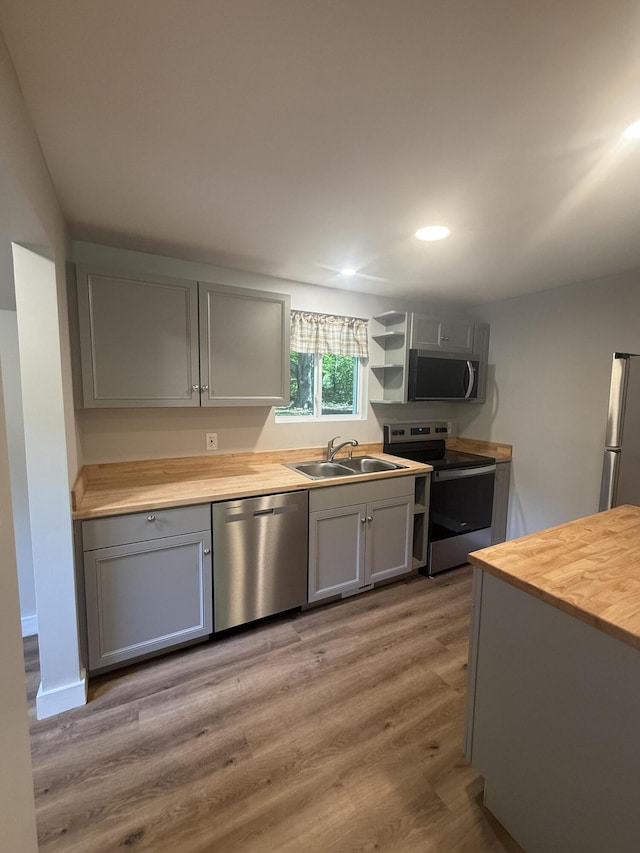 69 Heath St, Oakland, ME 04963 - kitchen with appliances with stainless steel finishes, wood counters, gray cabinetry, light wood-style floors, and recessed lighting