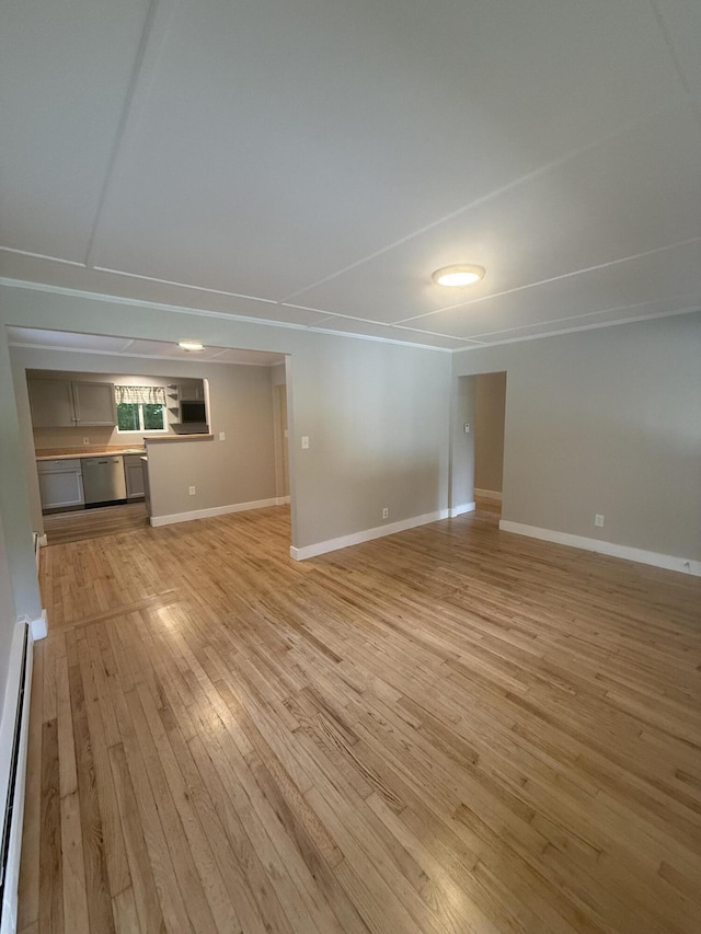 69 Heath St, Oakland, ME 04963 - unfurnished living room with light wood-style floors and a baseboard heating unit