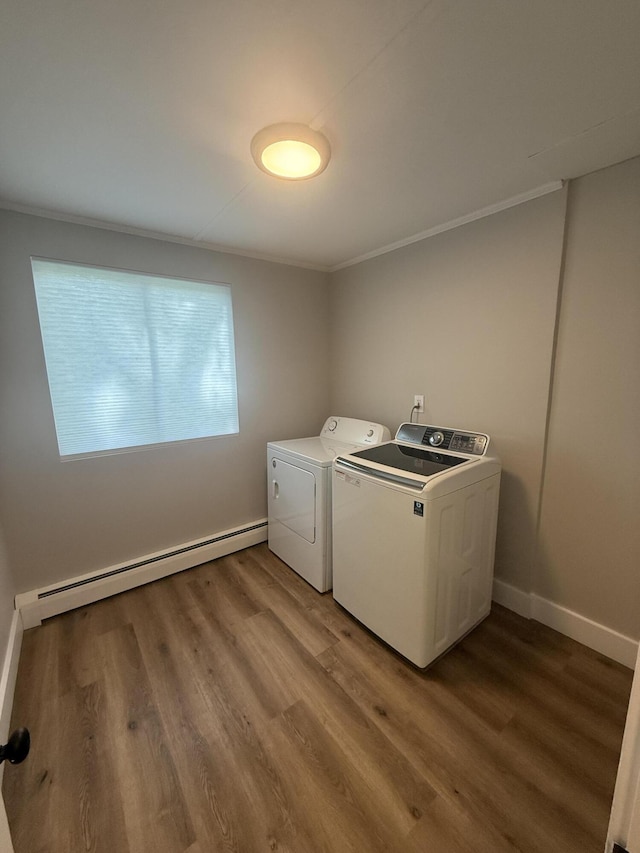 69 Heath St, Oakland, ME 04963 - laundry area featuring washer and dryer, baseboard heating, wood finished floors, and crown molding